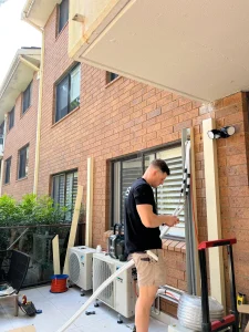 Air conditioning unit installation on a brick townhouse by Hassett Electrical