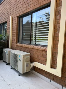 External air conditioning unit installed near a window on a residential property