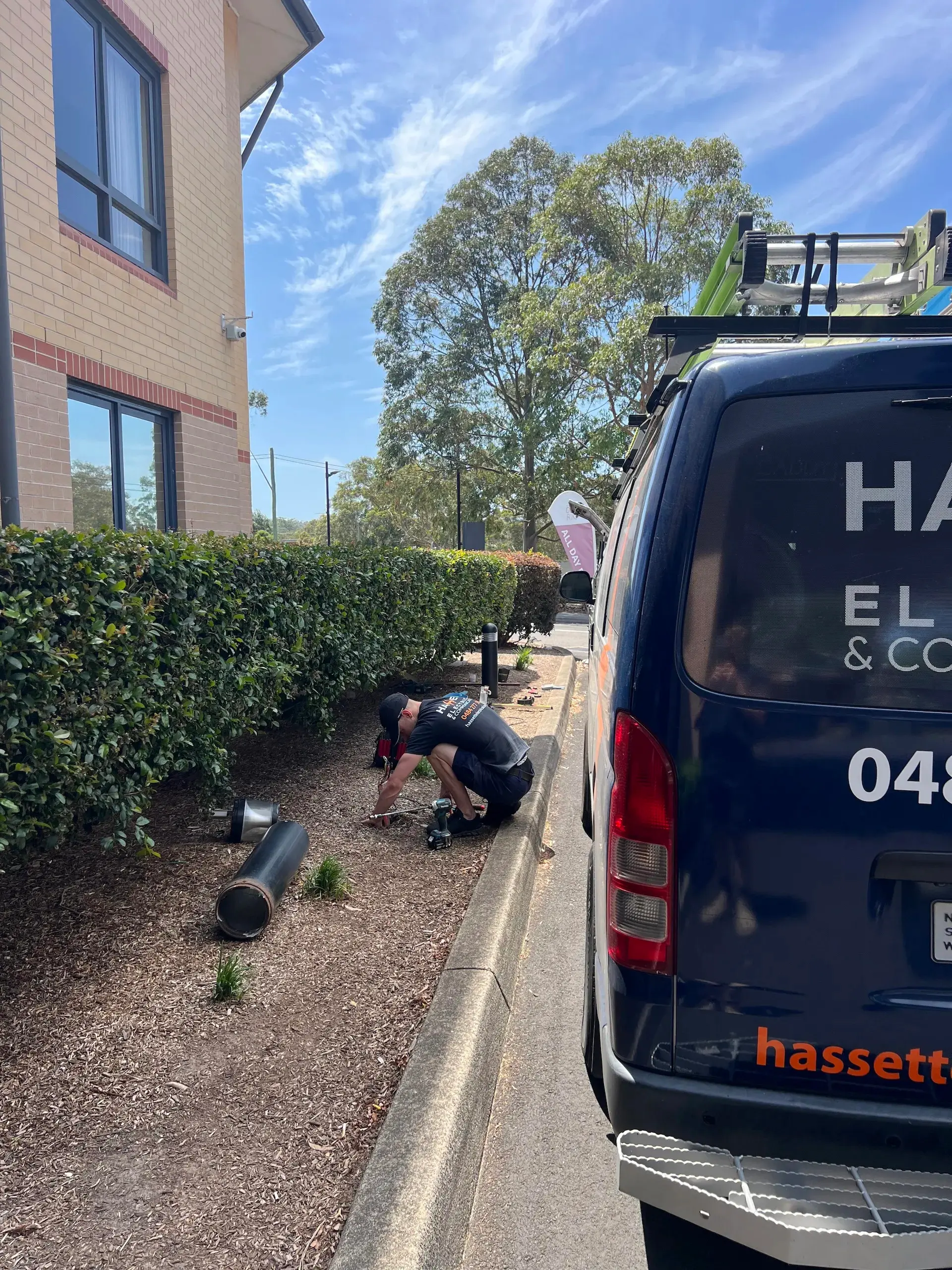 Hassett Electrical technician installing bollard lighting at the Mercure Hotel, Macquarie Park