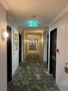 Completed hotel corridor lighting and emergency exit signage at the Mercure Hotel, Macquarie Park