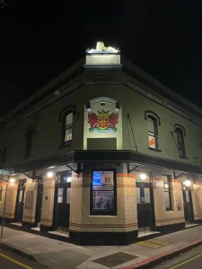 Illuminated heritage crest and facade lighting at the Carlisle Castle Hotel, Newtown — commercial lighting installation by Hassett Electrical