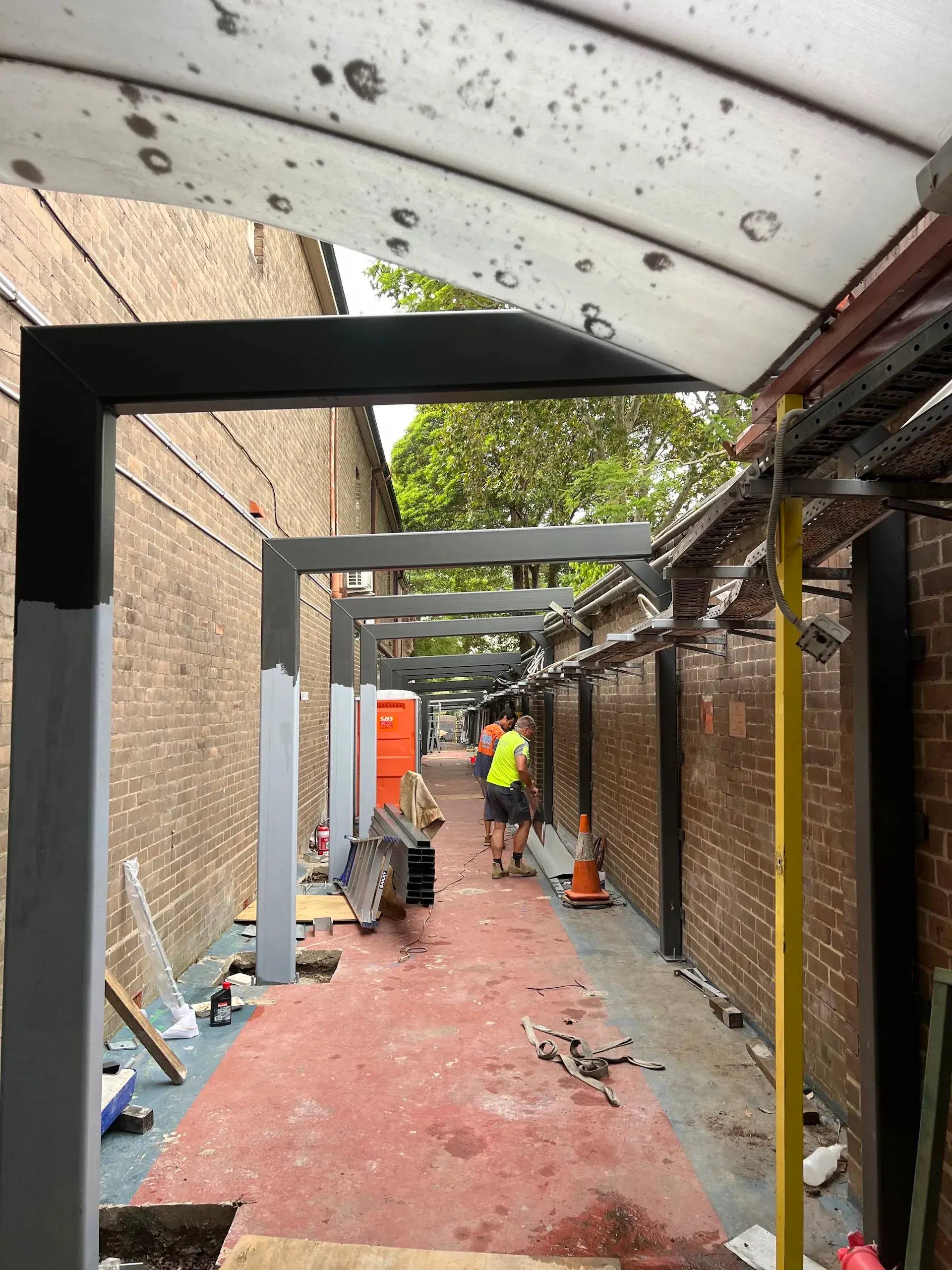 Covered walkway construction with electrical cable tray installation at St Maroun's College, Marrickville
