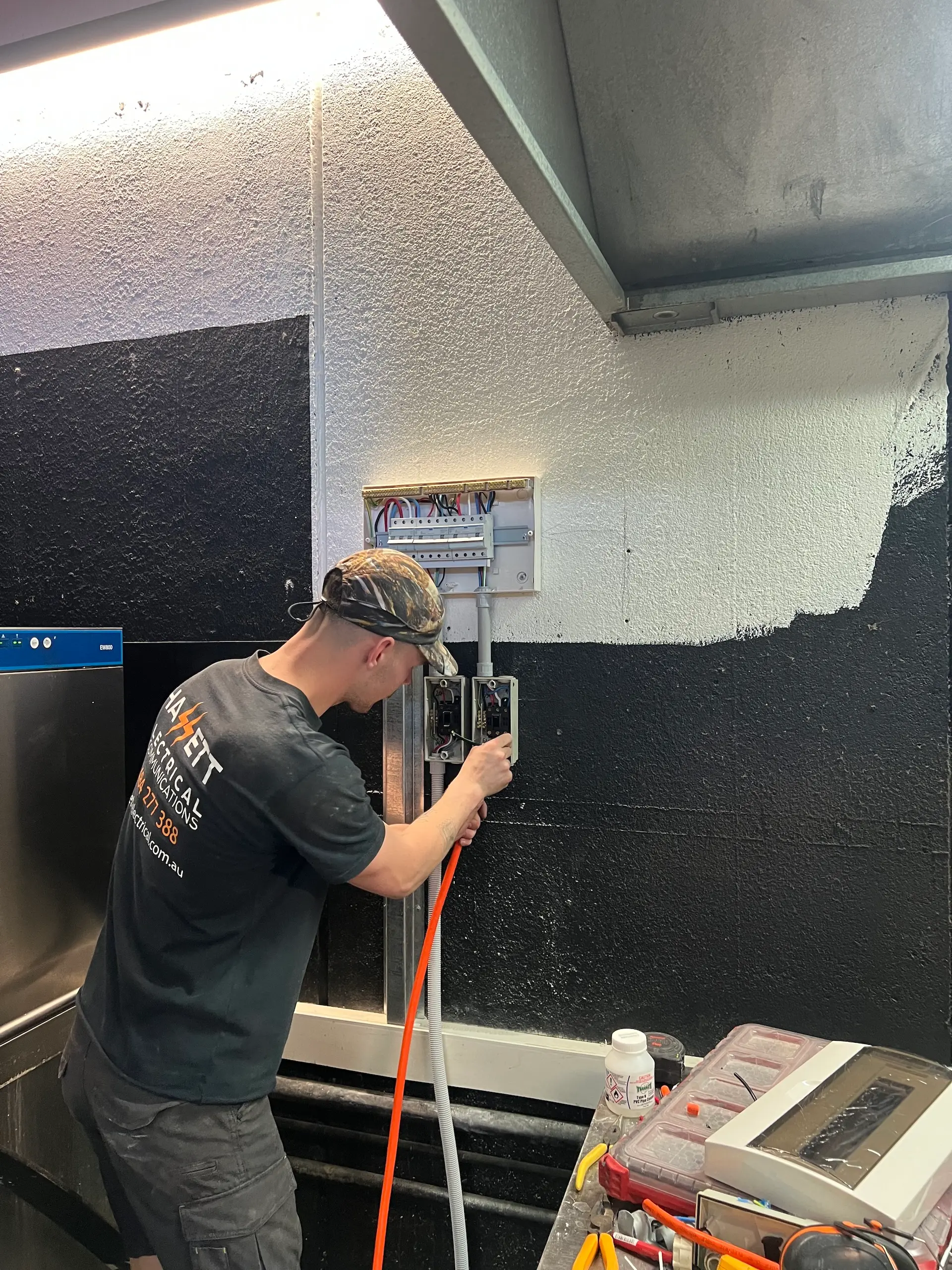 Hassett Electrical technician installing isolator switches during an industrial electrical job in Sydney