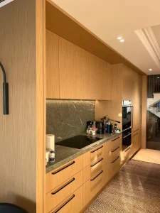 Kitchen joinery with integrated downlights and under-cabinet lighting in a Paddington home