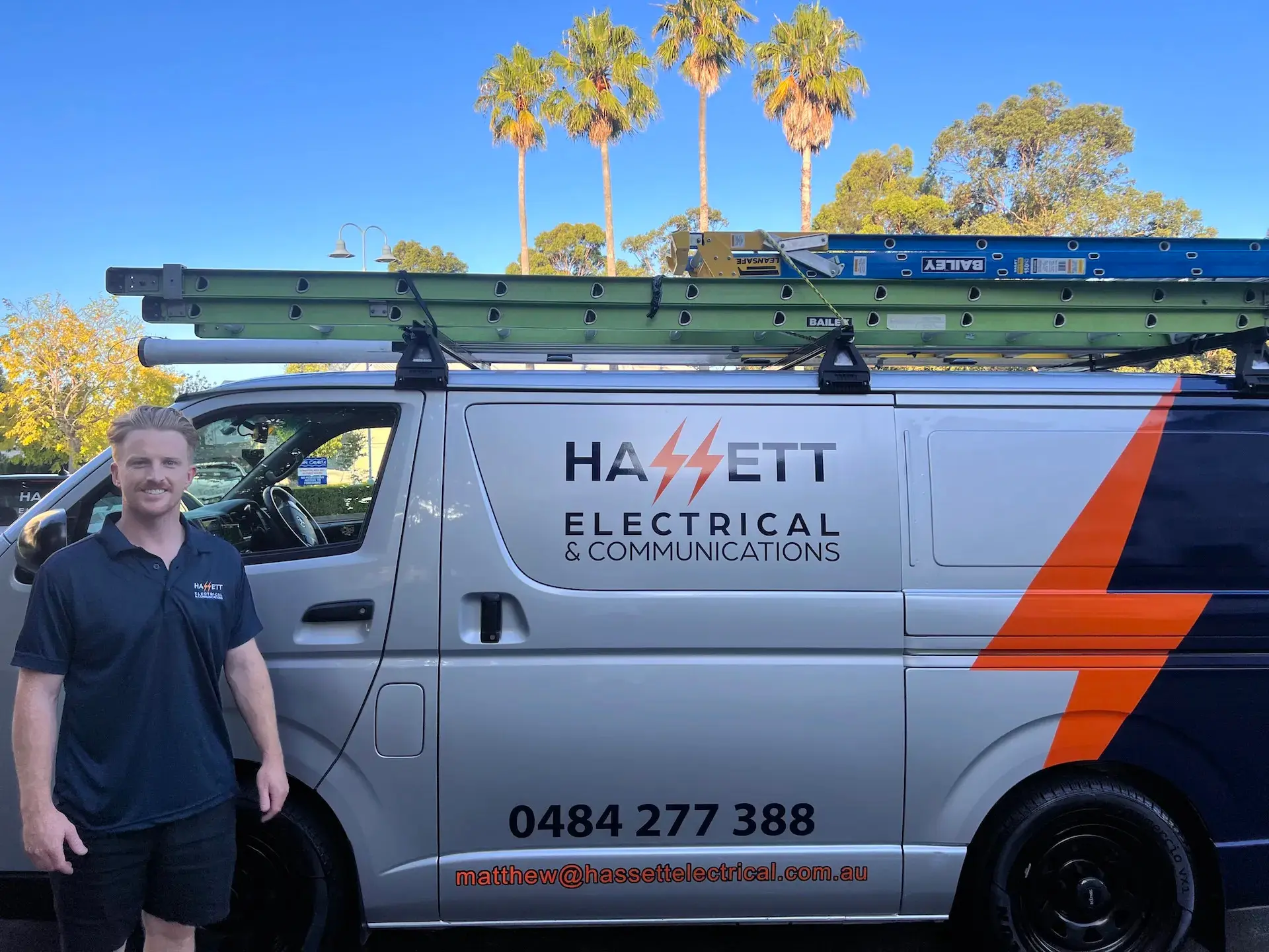 Matt from Hassett Electrical standing beside the company van in Inner West Sydney